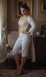 a woman that is posing in front of a couch