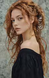 an attractive young woman with red hair looking at the camera