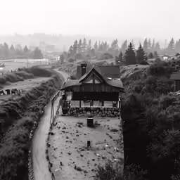 a small town is nestled in the fog by some mountains