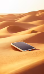 a cellphone laying in the middle of a desert