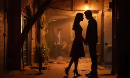 a man and a woman standing under a street light