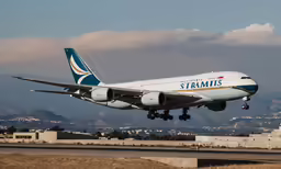 a large white and blue jetliner taking off