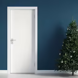 a modern door next to a christmas tree