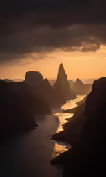 a view of mountains and water at sunset