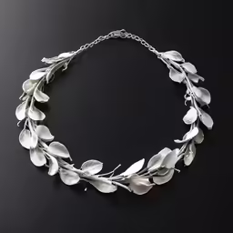 a silver necklace with leaves on it