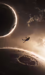 an image of a silhouette of a person on a kite high in the air