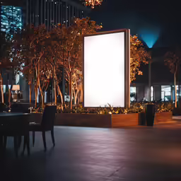 an empty screen stands in the middle of an open area near a building