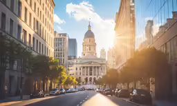 a wide street lined with tall buildings and trees