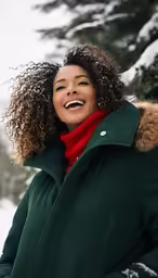 woman in coat laughing with large afro hair