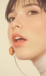 a woman wearing some kind of earrings