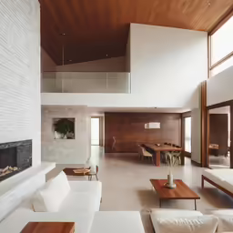 a very large living room has an open fireplace and a television