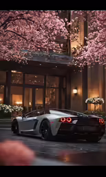 a car sitting under some pink flowers near the windows