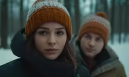 a man and woman are in the snow