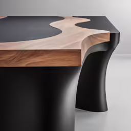 a wooden table with two metal legs and two black tops