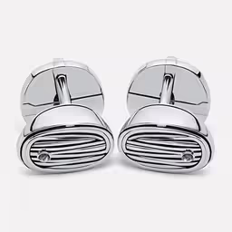 pair of silver cuff links with diamond details on white background