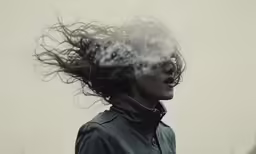 the woman with her hair blowing in the wind