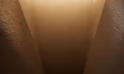 a lit up room with a lamp in the corner