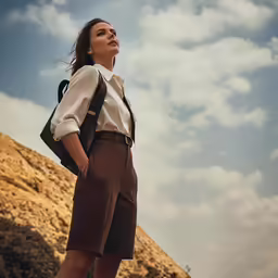 a woman wearing brown shorts and a white shirt