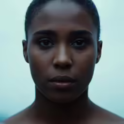 a woman is posing for a photo, with her eyes open