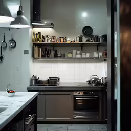 a clean kitchen with stainless steel appliances and white walls