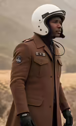 a man in a brown coat and a helmet is standing outside