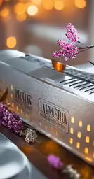 small purple flower sitting in a gold cup on top of an old amp