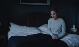 there is a woman that is sitting on a bed