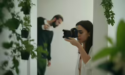a woman taking a photograph of herself in the mirror with a camera