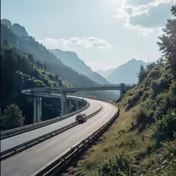 cars drive along a highway that runs beside a scenic area with mountains