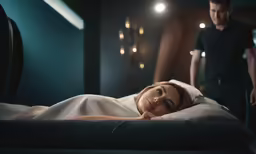 a woman laying on top of a bed next to a man
