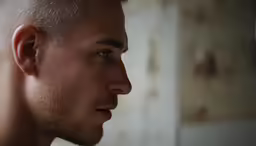 a man looking up at something while wearing a white shirt