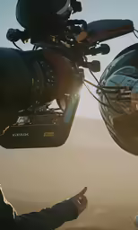 a person pointing at the rear view mirror of their vehicle