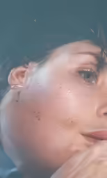 a girl with her hand under her face