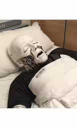 a headless person sleeping with his face on the pillows