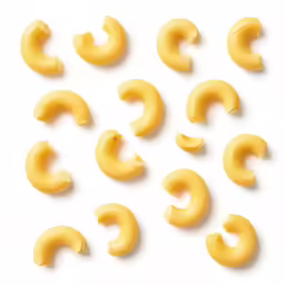 pasta noodles arranged in half on a white background