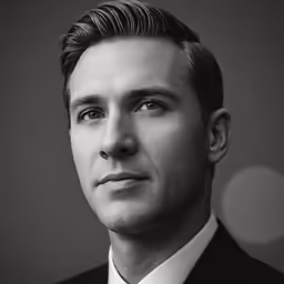a man is wearing a suit and tie