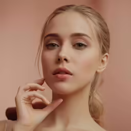a woman holding her hand near her face