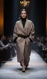 a model walks down the runway at an upscale fashion show