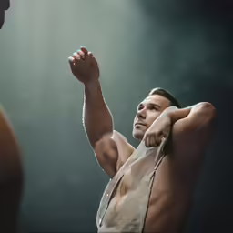 man stretching up with arm outstretched to show flexibility