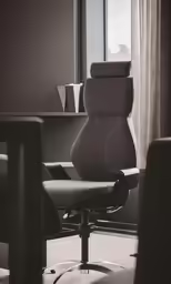 a chair is in front of a window and a table