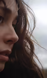 the woman has her long hair flowing in front of her face