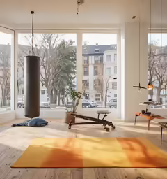 a living room with large windows and hardwood floors