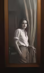 a woman in a button up shirt is standing next to curtains