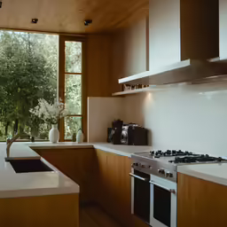 a kitchen with a counter top stove and sink
