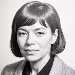a woman with a tie is wearing a jacket