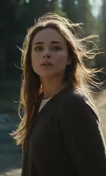 the girl is wearing long hair standing on dirt