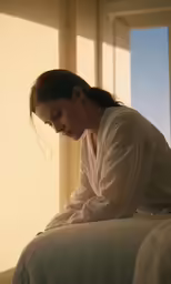 a woman that is sitting on top of a bed