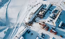 an aerial view of snow covered houses and roads