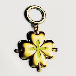 this flower is shaped like a four - leaf clover,an elegant gold flower keychain is featured in this photo