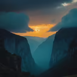 a very scenic scene with a cloudy sky and mountains